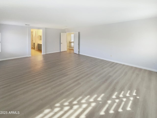 spare room with wood-type flooring