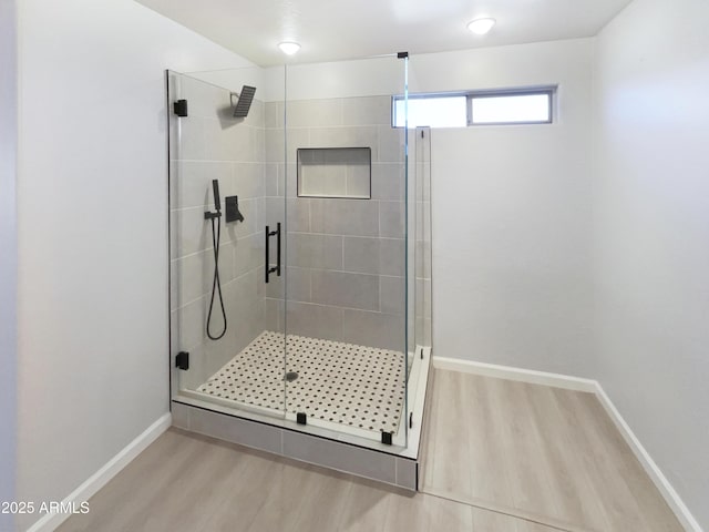 bathroom featuring hardwood / wood-style floors and walk in shower