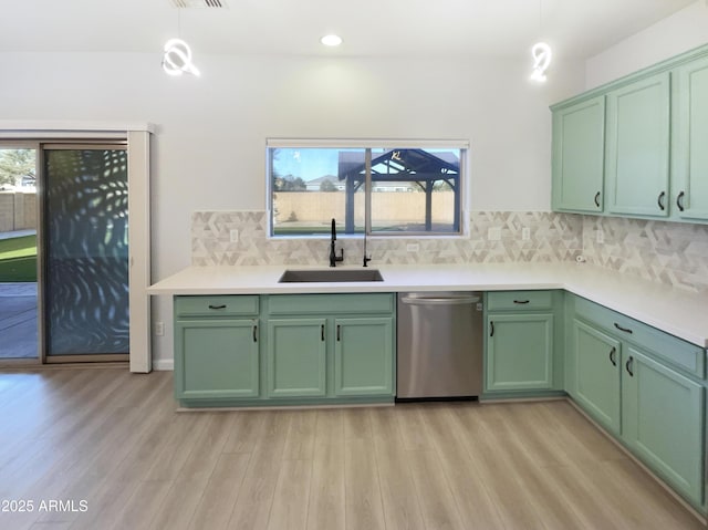 kitchen featuring green cabinets, sink, and stainless steel dishwasher