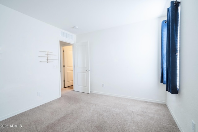 unfurnished room with light colored carpet