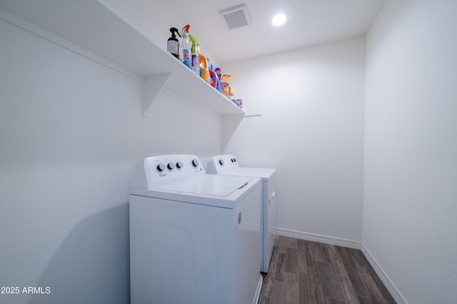 washroom with dark hardwood / wood-style flooring and washer and clothes dryer