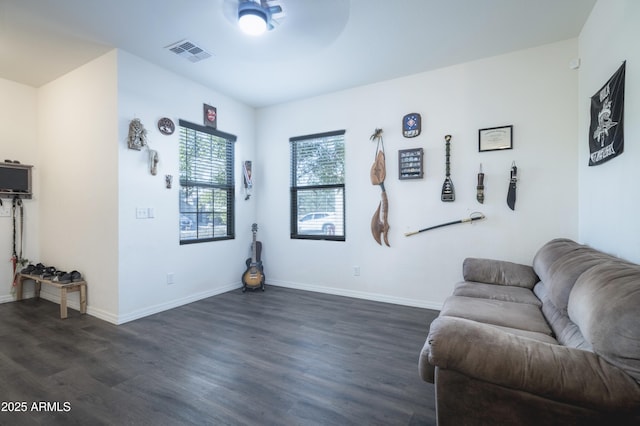 living room with dark hardwood / wood-style floors and ceiling fan