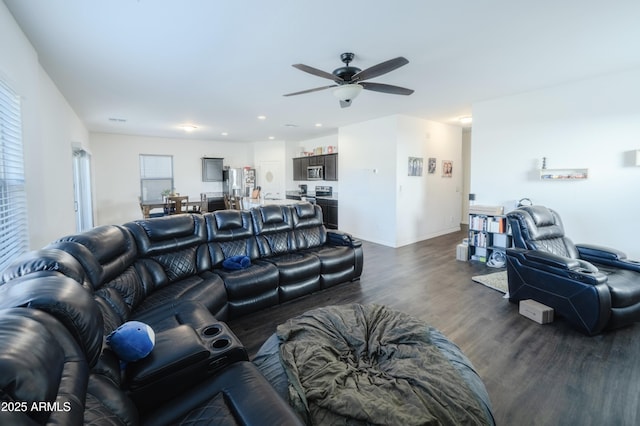 living room featuring dark hardwood / wood-style flooring and ceiling fan