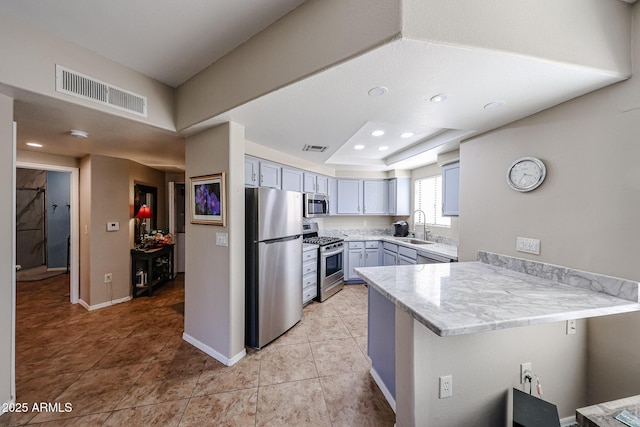 10030 W Indian School Rd Unit 101, Phoenix, AZ 85037 - kitchen featuring stainless steel appliances, a peninsula, and light tile patterned flooring