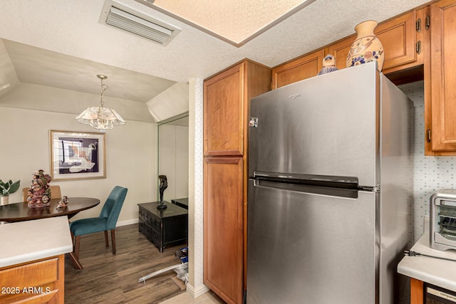 839 S Westwood Unit 287, Mesa, AZ 85210 - kitchen with freestanding refrigerator, light wood-style flooring, brown cabinets, a chandelier, and lofted ceiling