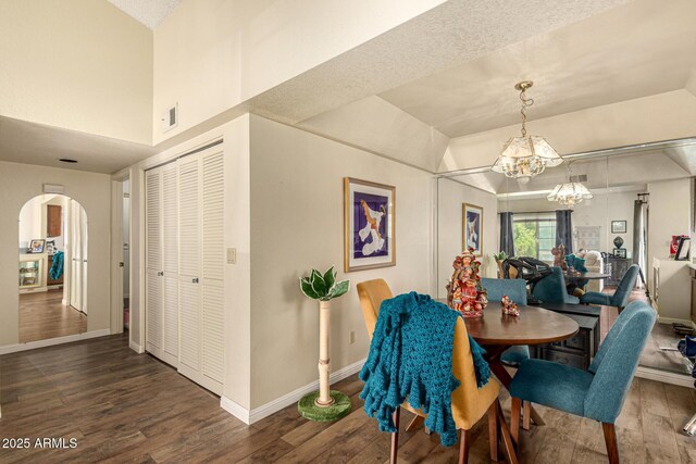 839 S Westwood Unit 287, Mesa, AZ 85210 - dining space with arched walkways, a chandelier, wood finished floors, and baseboards