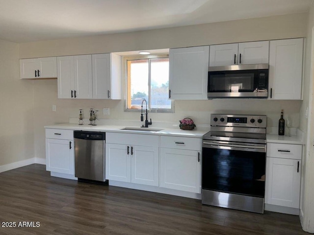 kitchen featuring sink, dark wood-type flooring, white cabinets, and appliances with stainless steel finishes