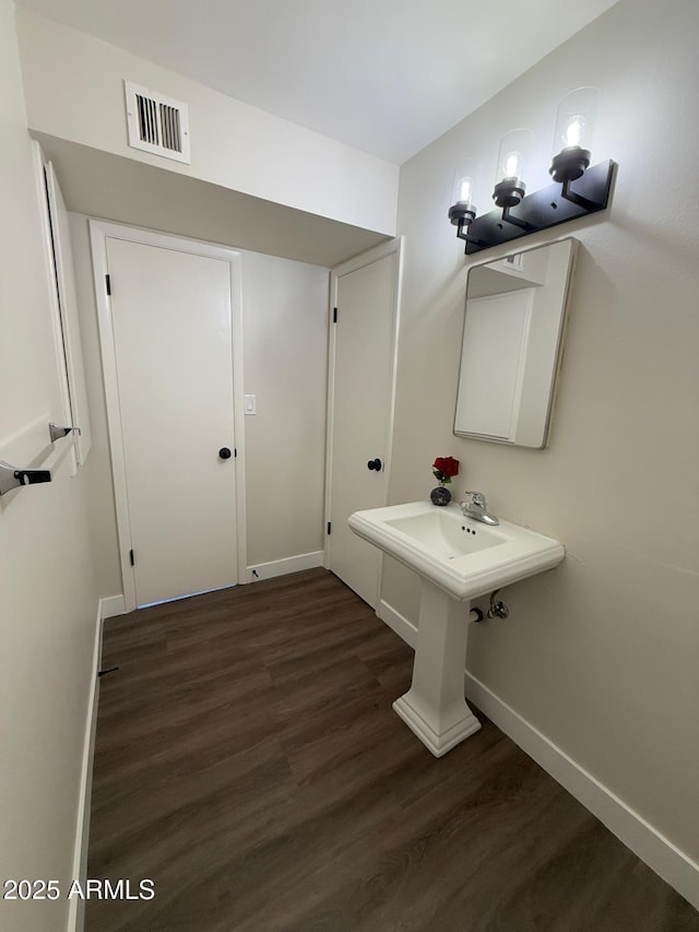 bathroom with hardwood / wood-style flooring