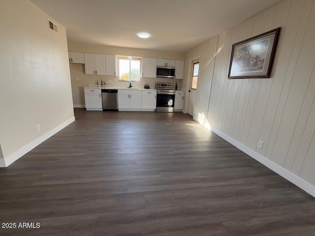 kitchen with white cabinetry, stainless steel appliances, dark hardwood / wood-style flooring, and sink