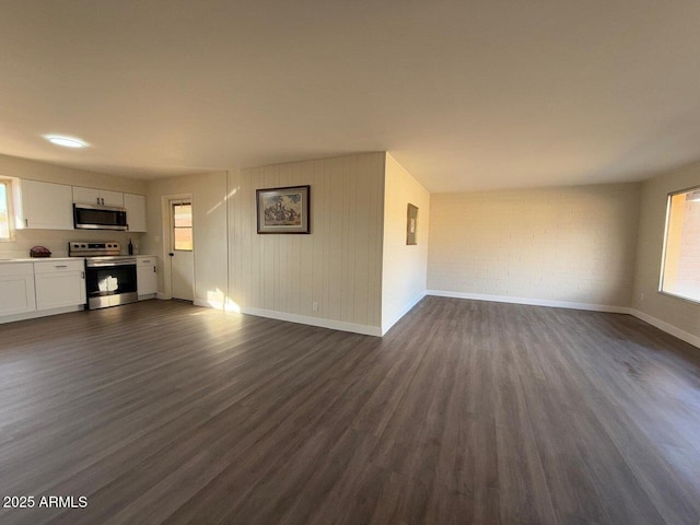 unfurnished living room with dark hardwood / wood-style flooring