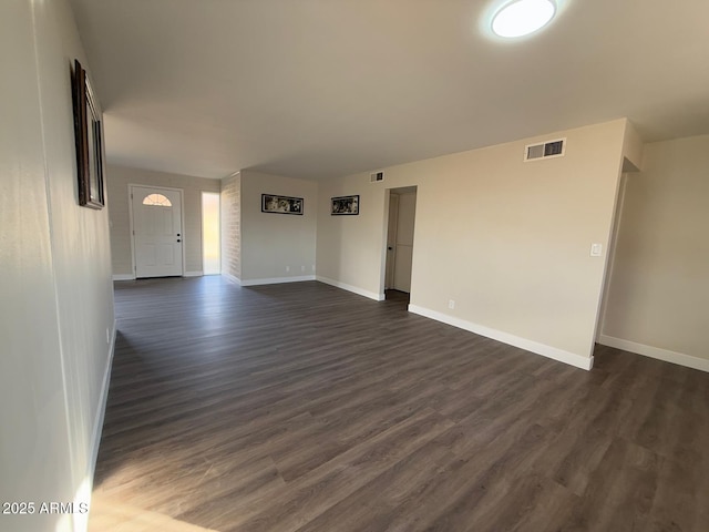 empty room featuring dark hardwood / wood-style flooring