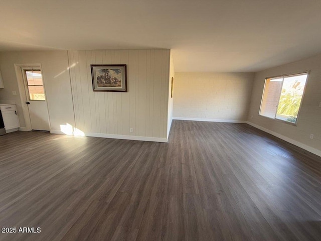 spare room with dark hardwood / wood-style floors