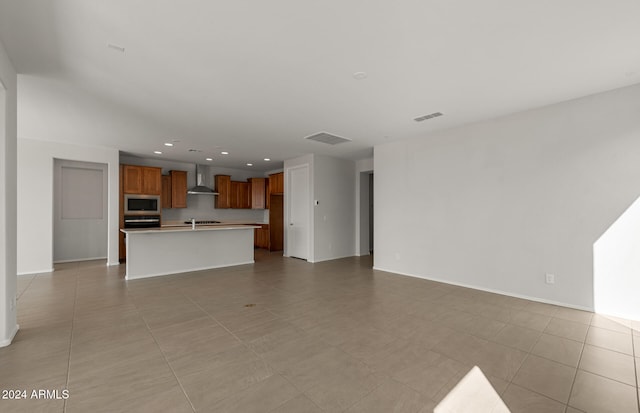 unfurnished living room featuring sink and light tile patterned floors