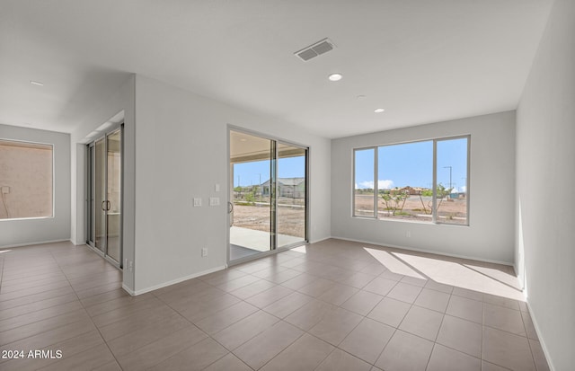 unfurnished room with light tile patterned floors