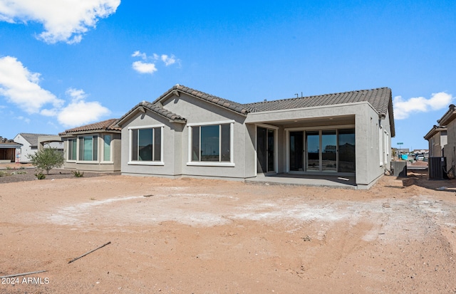 rear view of property with central AC