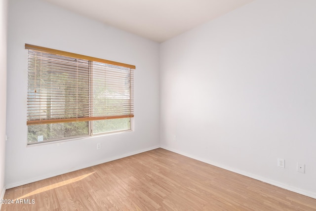 empty room with light hardwood / wood-style flooring