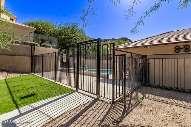 view of gate featuring a community pool