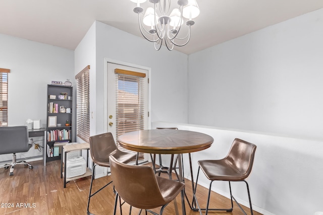 dining area with a notable chandelier and wood-type flooring