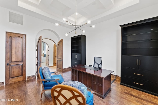 office area featuring light hardwood / wood-style floors, beamed ceiling, a notable chandelier, and coffered ceiling