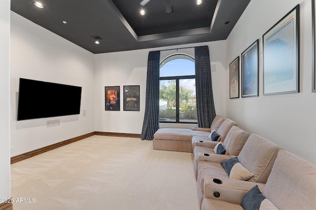 carpeted living room with a raised ceiling