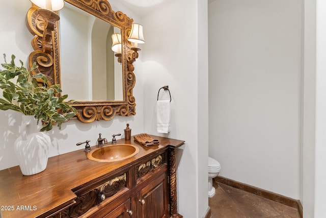 bathroom featuring toilet, vanity, and tile patterned flooring