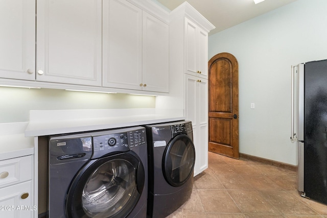 washroom featuring cabinets and washer and dryer