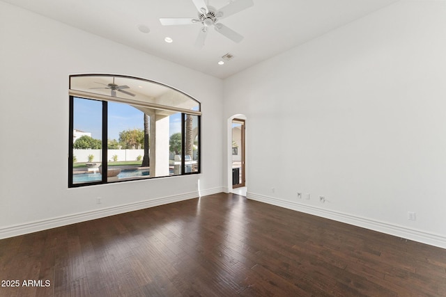 unfurnished room with ceiling fan, dark hardwood / wood-style flooring, and lofted ceiling