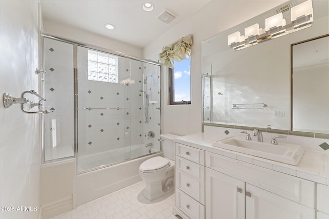 full bathroom featuring tile patterned floors, shower / bath combination with glass door, vanity, and toilet