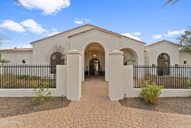 mediterranean / spanish-style home with french doors