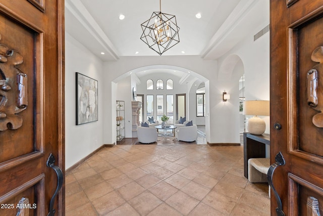 foyer entrance with a towering ceiling and an inviting chandelier