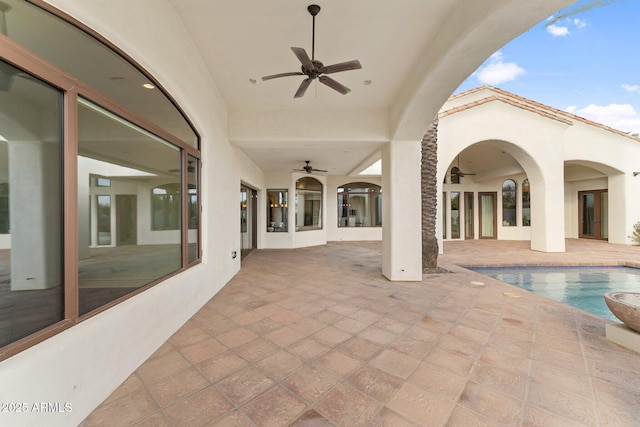 view of pool featuring ceiling fan and a patio