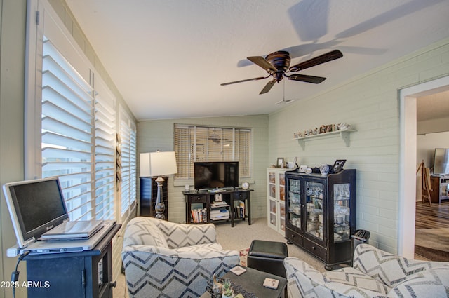 carpeted living room featuring ceiling fan and lofted ceiling