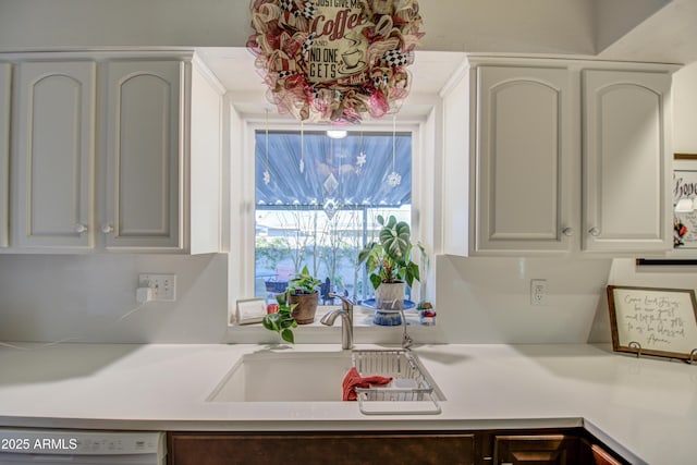 kitchen with white cabinets, dishwasher, and sink