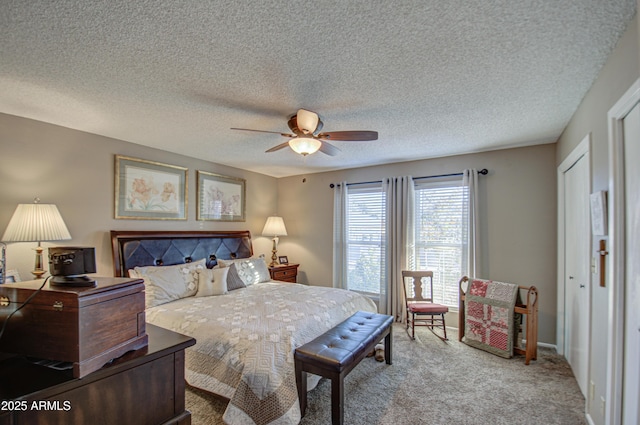 carpeted bedroom with a textured ceiling and ceiling fan