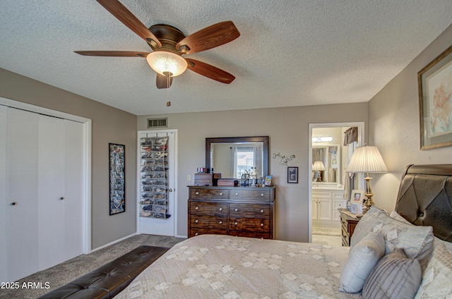 bedroom featuring connected bathroom, a closet, ceiling fan, carpet flooring, and a textured ceiling