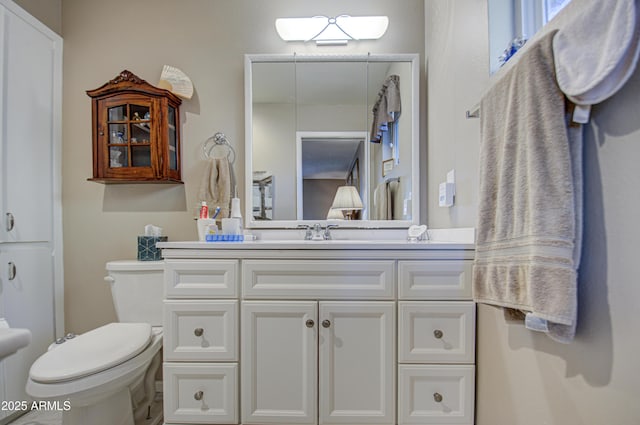 bathroom with vanity and toilet