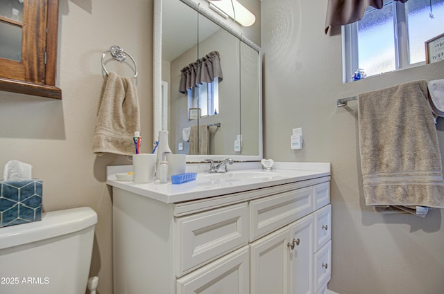 bathroom featuring toilet and vanity