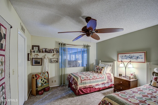 carpeted bedroom with a textured ceiling and ceiling fan