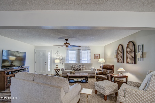 living room featuring a textured ceiling and ceiling fan