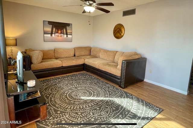 living room with wood-type flooring and ceiling fan