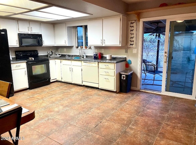 kitchen with black appliances, white cabinetry, and sink