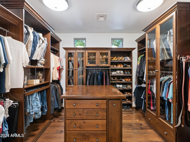 spacious closet featuring dark hardwood / wood-style flooring