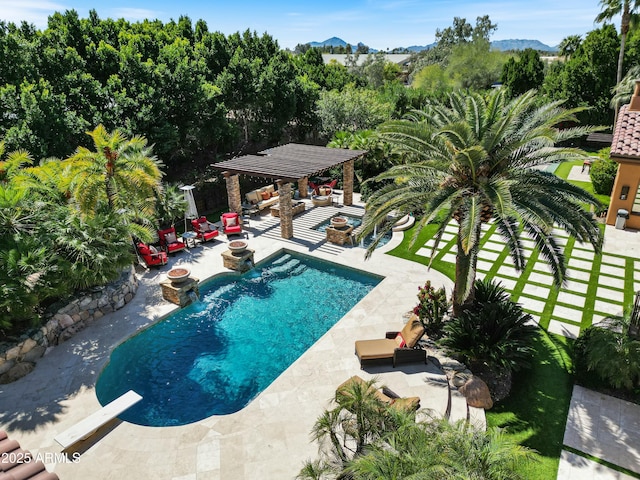 pool with a hot tub, a gazebo, a patio area, a mountain view, and a fire pit