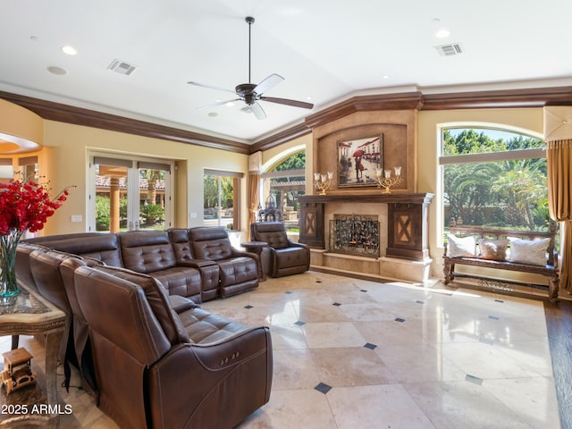 living room with plenty of natural light, vaulted ceiling, a fireplace, and visible vents