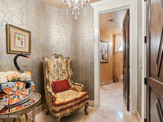 sitting room with wallpapered walls, visible vents, and baseboards