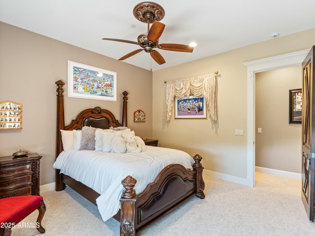 bedroom featuring a ceiling fan, light carpet, and baseboards