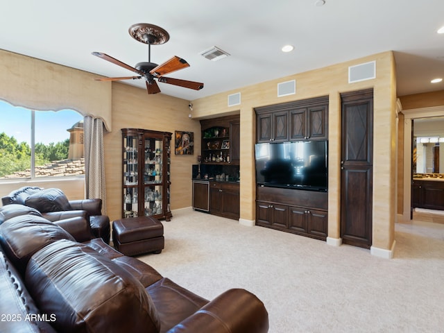 living area featuring light carpet, a dry bar, baseboards, visible vents, and recessed lighting