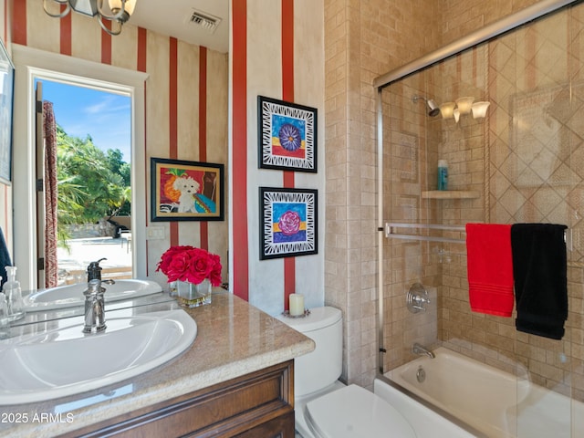 full bath featuring enclosed tub / shower combo, toilet, vanity, and visible vents