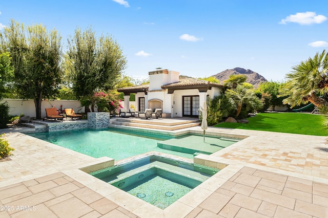 5740 N Casa Blanca Dr, Paradise Valley, AZ 85253 - view of swimming pool featuring a mountain view, a patio area, a pool with connected hot tub, fence, and french doors