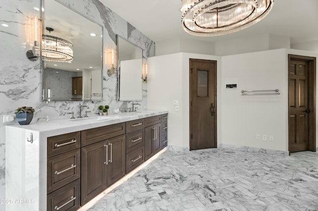 5740 N Casa Blanca Dr, Paradise Valley, AZ 85253 - full bathroom with a sink, double vanity, marble finish floor, and a notable chandelier
